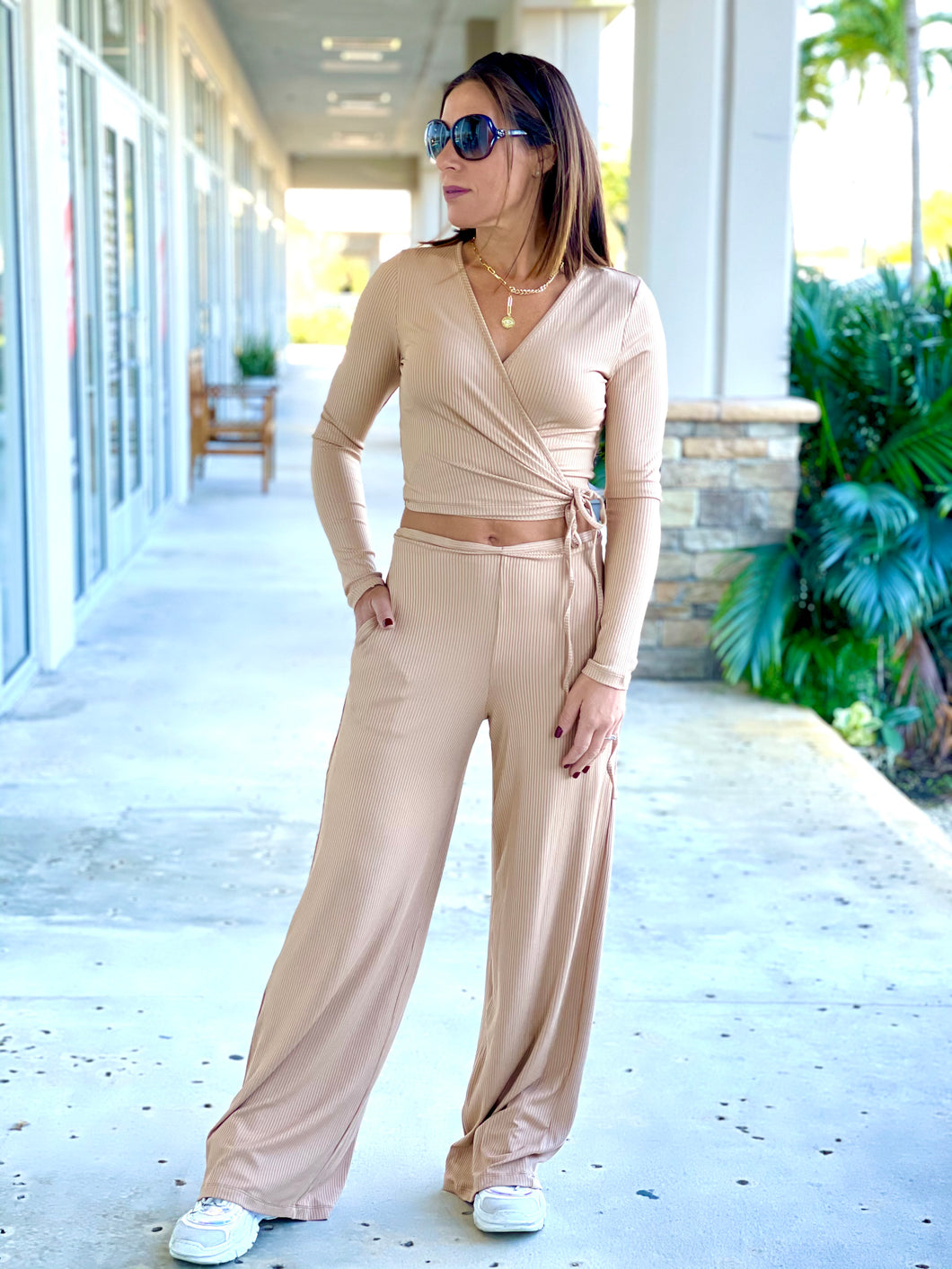 Ribbed knit set with long sleeve wrap surplice top and matching wide leg pant with pockets and elastic band